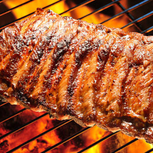Menu grilled pork ribs on the grill.